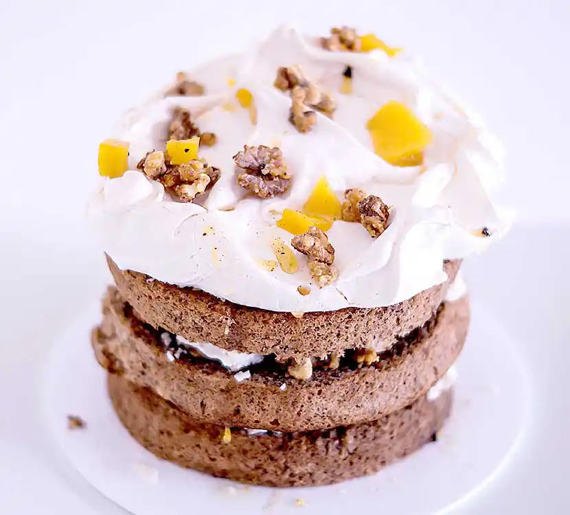 Teller mit Walnusskuchen mit Mango und Baiser Topping.